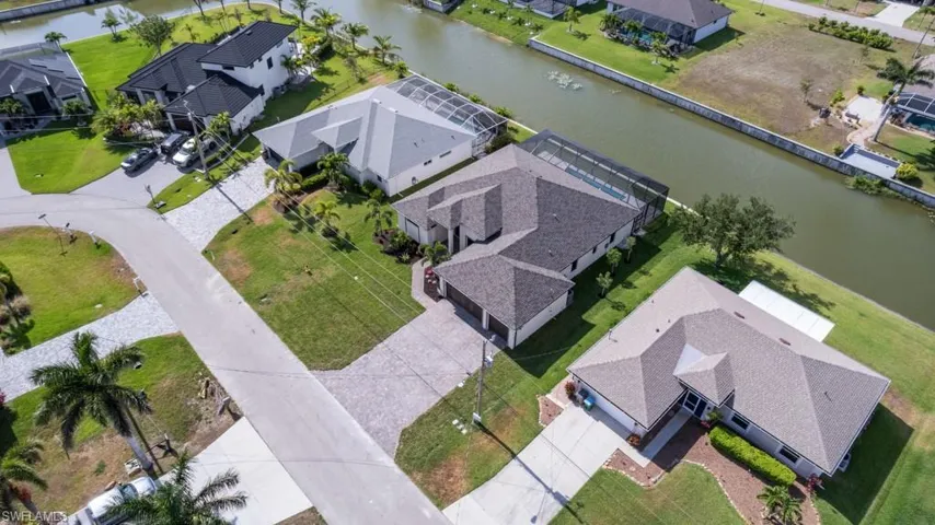 Aerial perspective of suburban area with a nearby body of water