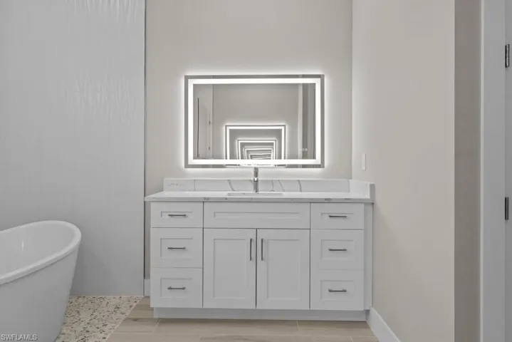 Bathroom with a freestanding tub and vanity