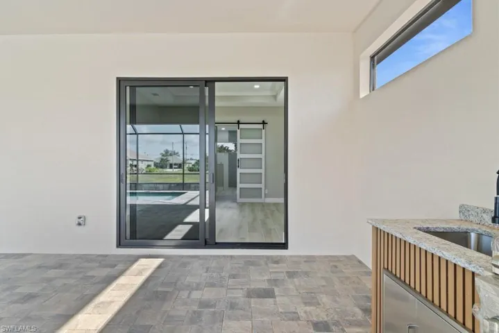 Entrance to property featuring stucco siding and a sink