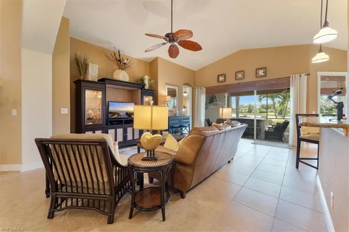 Beautifully furnished living room with cathedral ceilings.