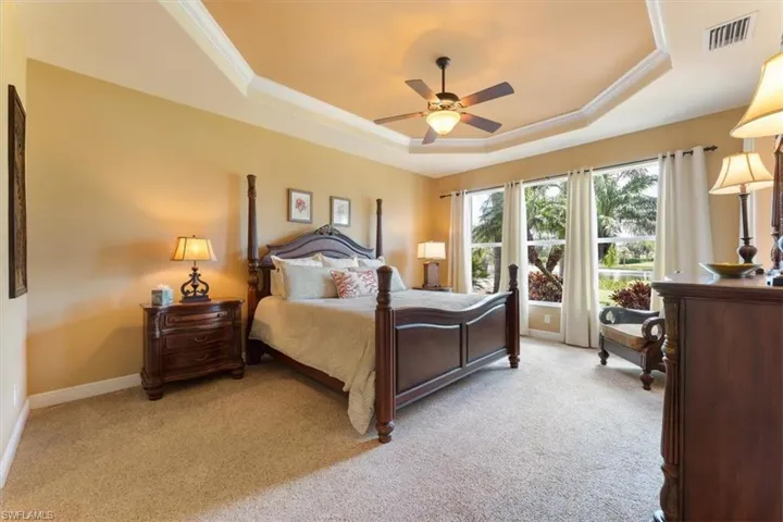 Spacious master bedroom facing the lake featuring large windows with abundant natural light.