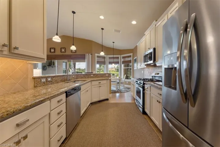 Stainless steel appliances including natural gas range & spacious granite counters highlight the kitchen. Refrigerator & microwave new in 2023.