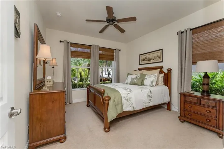 Guest bedroom with large double windows.