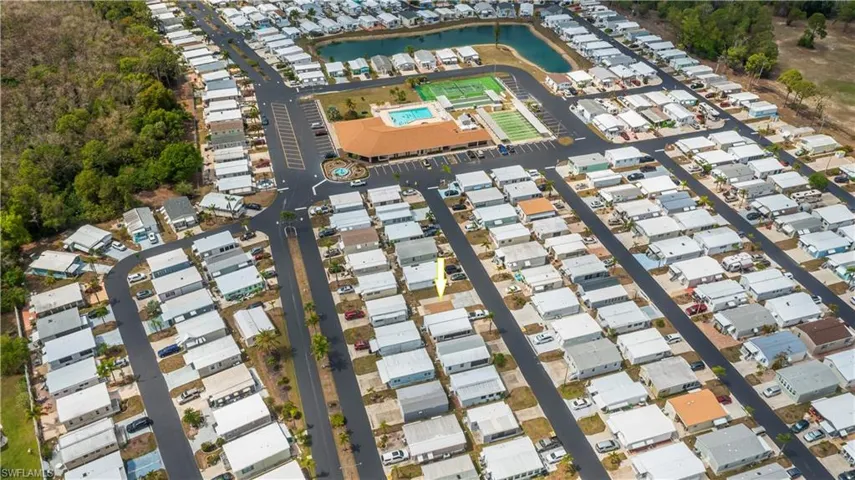 Aerial view of property and surrounding area with a nearby body of water