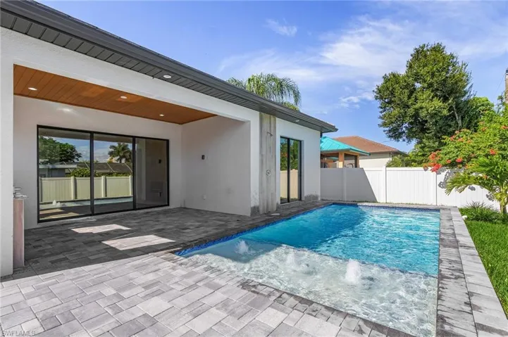 View of pool with a fenced backyard and patio surround