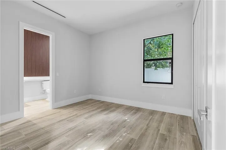 Unfurnished bedroom with light wood-type flooring