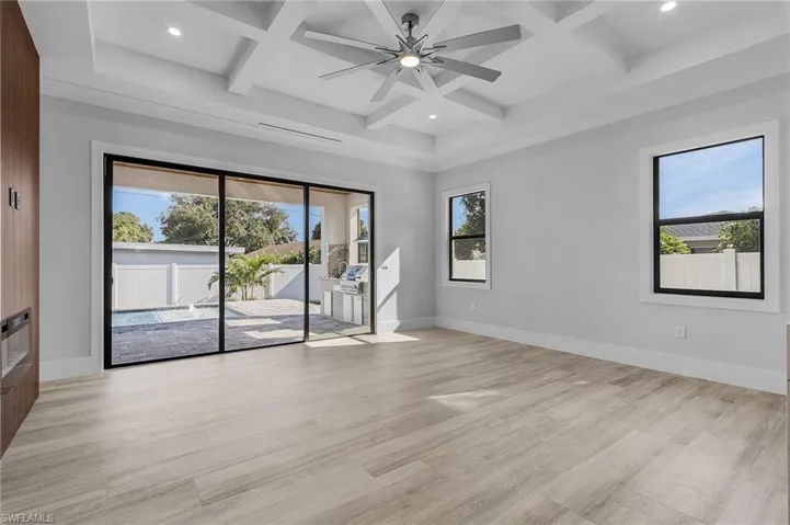 Unfurnished room with a ceiling fan, coffered ceiling, recessed lighting, and light wood-style floors
