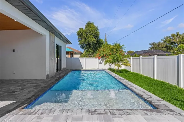 View of pool featuring a fenced backyard and patio surround