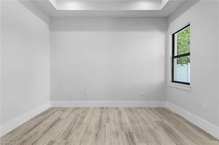 Empty room with light wood-style floors and baseboards
