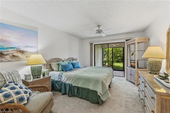 Spacious primary bedroom with lanai views