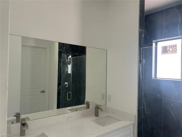 Bathroom with vanity and walk in shower