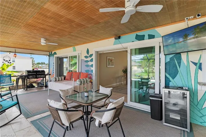 Sunroom featuring ceiling fan and outdoor dining area