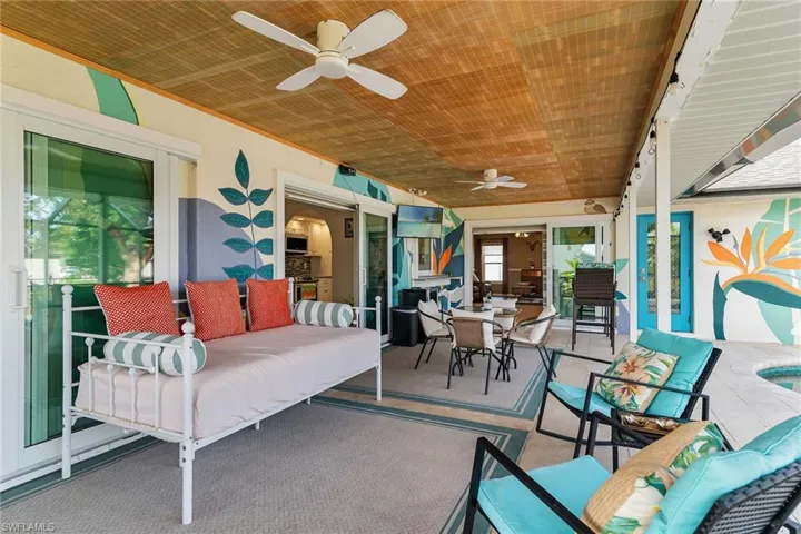 Sunroom with outdoor dining area, outdoor lounge area, a patio area, and ceiling fan