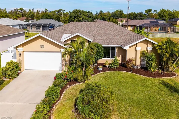 Single story home featuring stucco siding, roof with shingles, concrete driveway, a residential view, and an attached garage