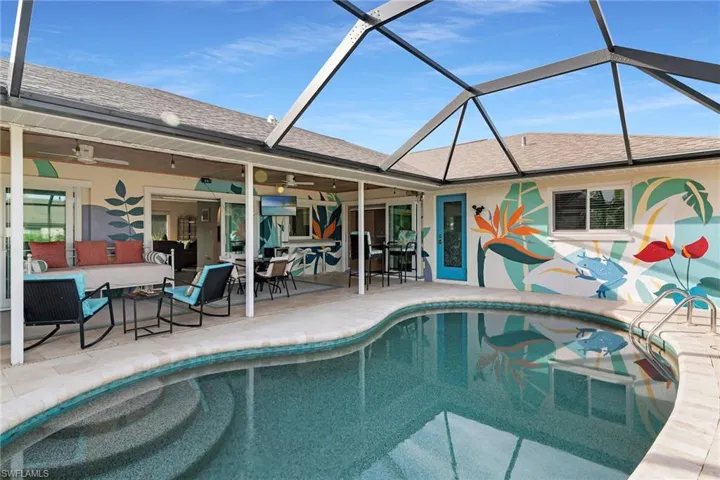 Outdoor pool featuring a sunroom, a patio area, outdoor dining area, and an outdoor hangout area