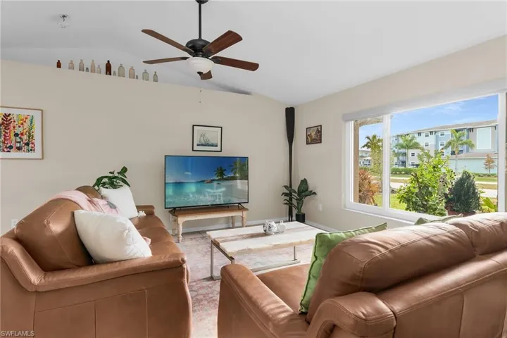 Living area featuring lofted ceiling and ceiling fan
