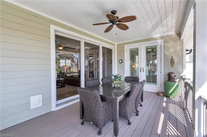 Wooden terrace featuring ceiling fan/  virtually enhanced photo
