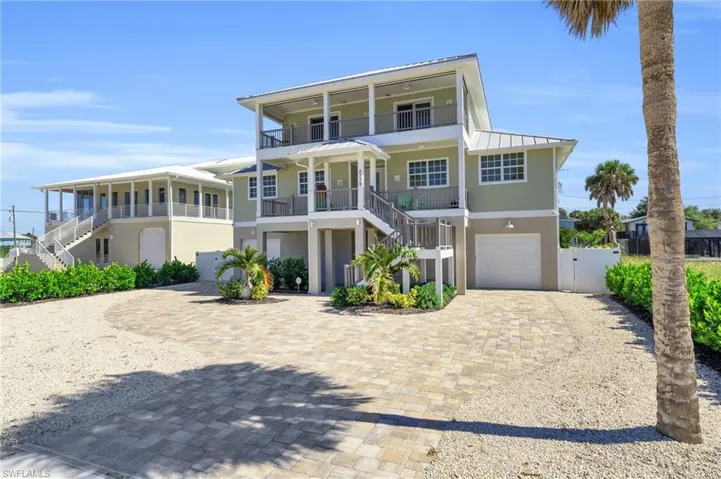 View of front of house with a balcony, a garage, and covered porch VIRTUALLY ENHANCED