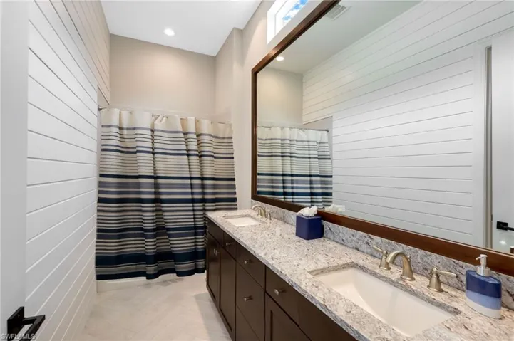 Bathroom with wood walls and vanity
