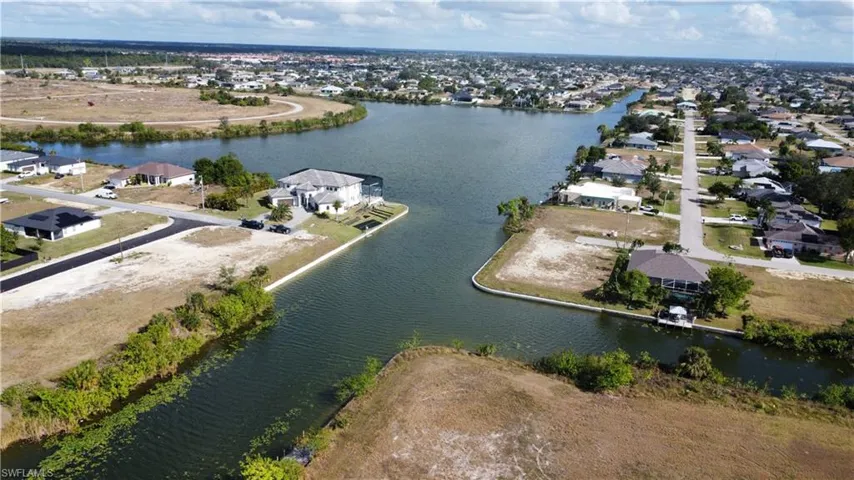 Birds eye view of property with a water view