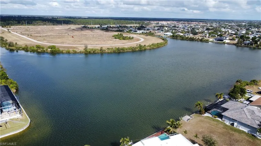 Birds eye view of property with a water view