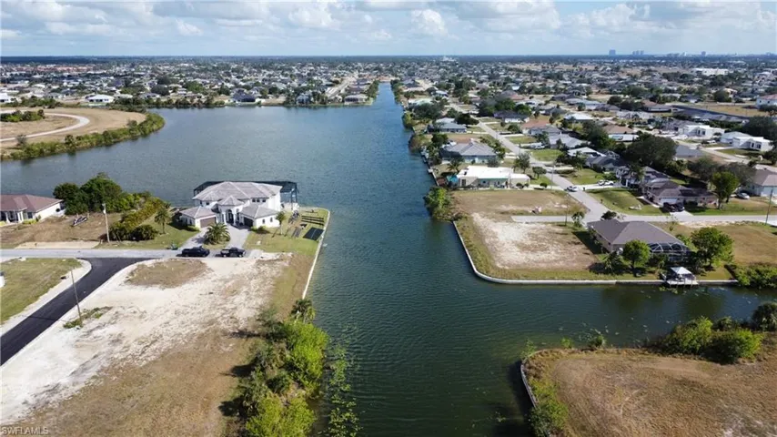 Birds eye view of property with a water view