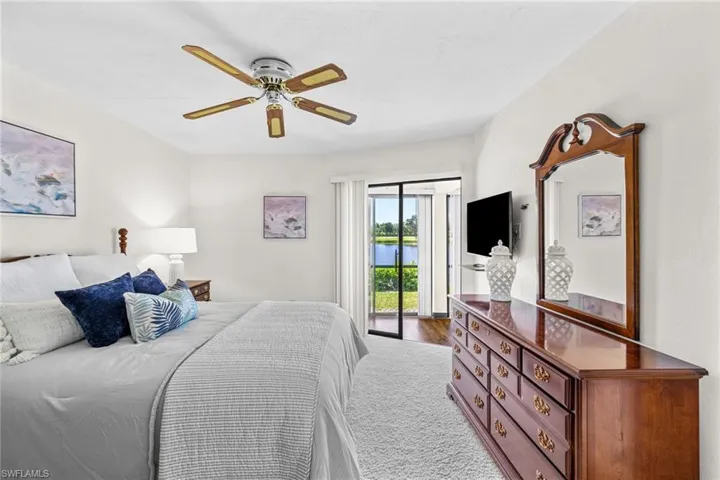 Bedroom with carpet floors, ceiling fan, and access to exterior