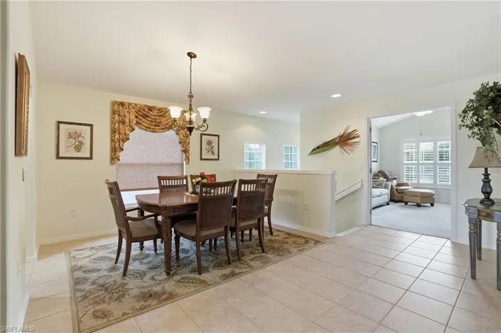 Dining room with a chandelier, recessed lighting, and light tile patterned floors