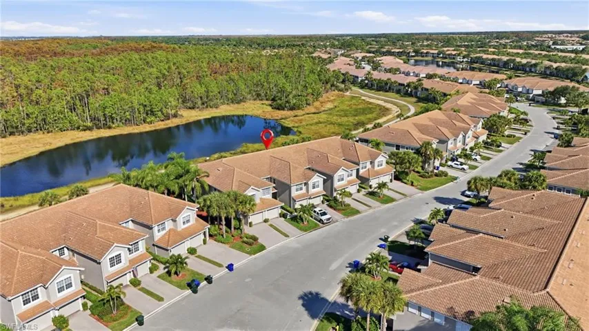 Aerial view of residential area featuring a nearby body of water