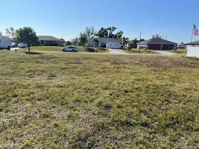 View of green lawn featuring a residential view