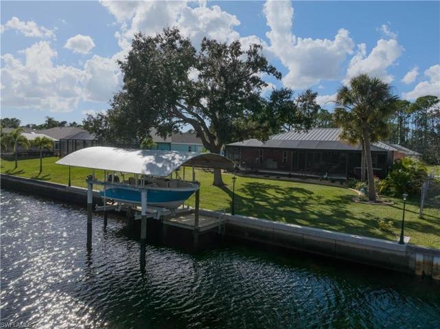 Western view of canal boat lift and backyard