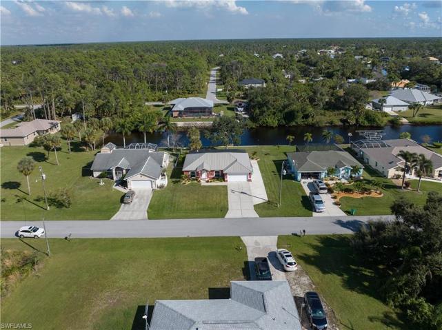High aerial frontal view of home and canal