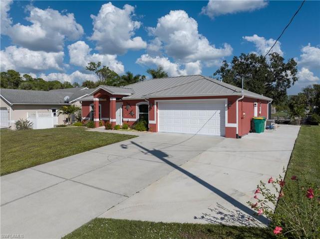 Southwestern corner view of home and wide driveway for RV and other