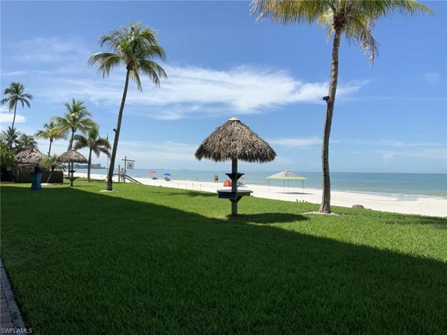 Beautiful landscaped area with tiki tables pre Ian