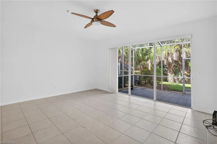 Spacious interior with tile flooring and a ceiling fan