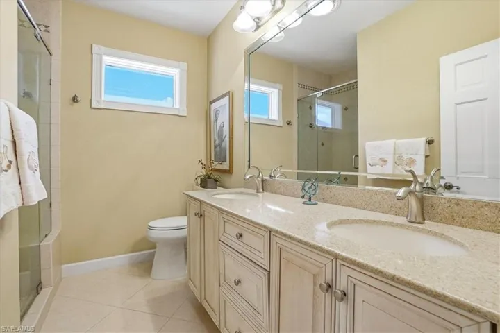 Dual vanity with undermount sinks and light-toned countertops