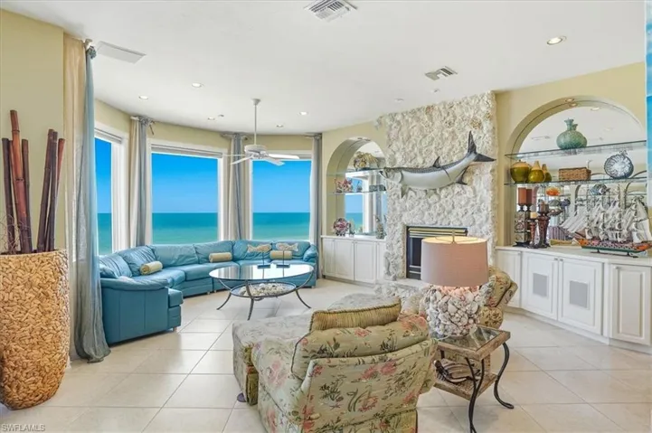 Expansive living area featuring large bay windows overlooking the ocean