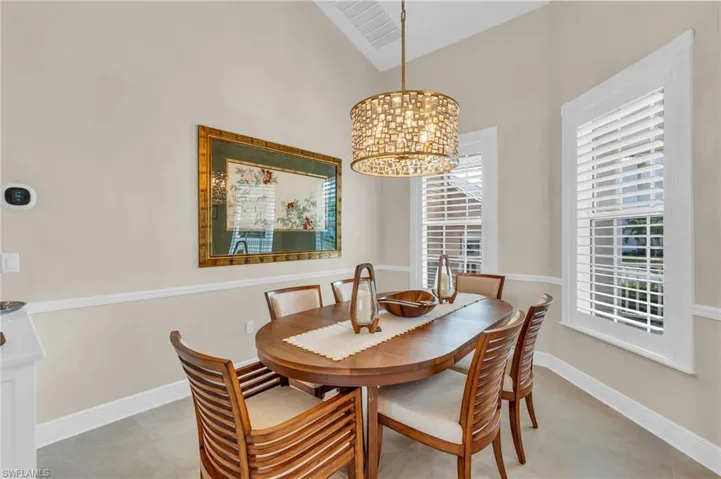 Dining room featuring a chandelier and lofted ceiling