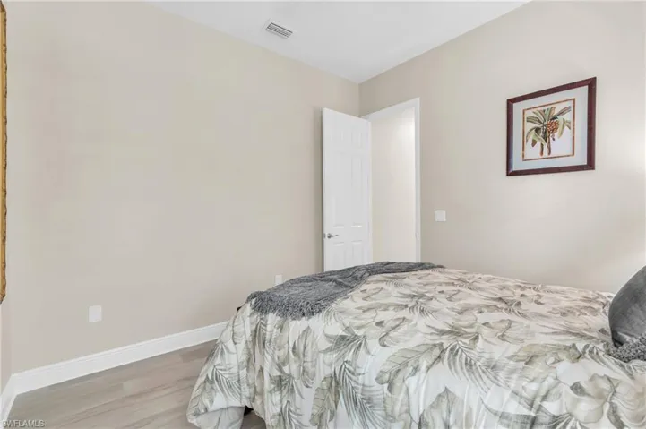 Bedroom with light hardwood / wood-style flooring