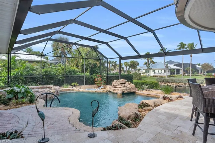 View of swimming pool featuring a lanai, a patio area, and pool water feature