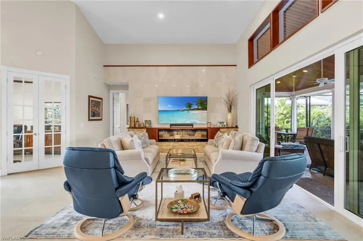 Living room with french doors and a high ceiling