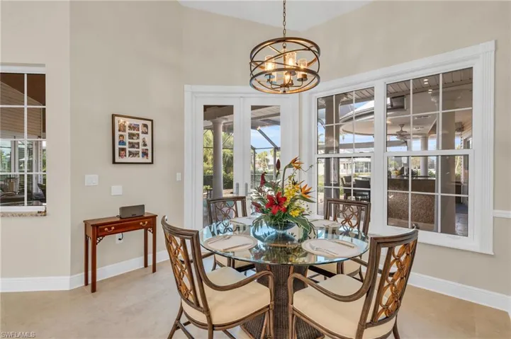 Tiled dining room featuring a chandelier