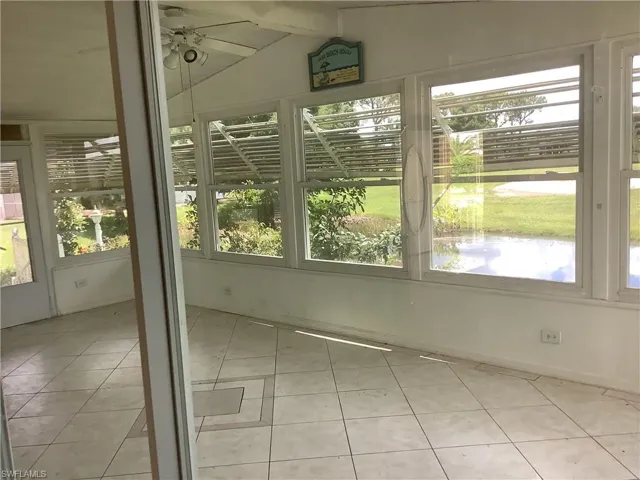 Unfurnished sunroom featuring tile patterned flooring