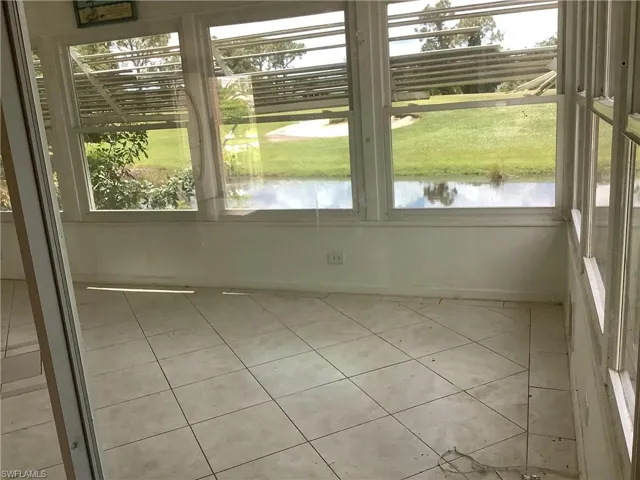 Unfurnished sunroom featuring healthy amount of natural light and a water view