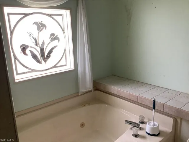Full bathroom featuring a whirlpool tub