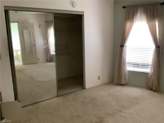 Unfurnished bedroom featuring carpet and a closet