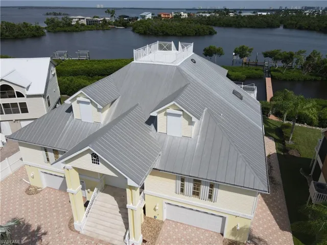 Birds eye view of property with a water view