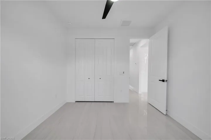 Unfurnished bedroom featuring a closet and a ceiling fan