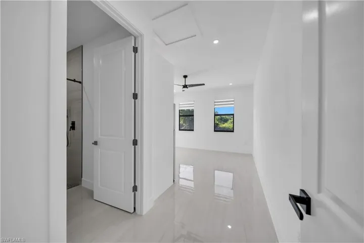 Hall featuring attic access and recessed lighting