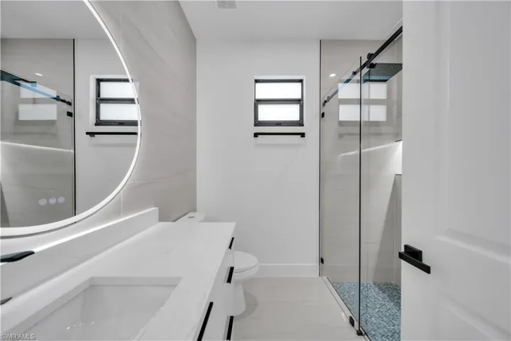 Bathroom featuring vanity and a stall shower
